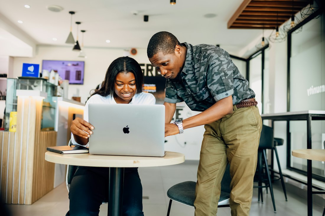 Two readers planning a move abroad on a laptop